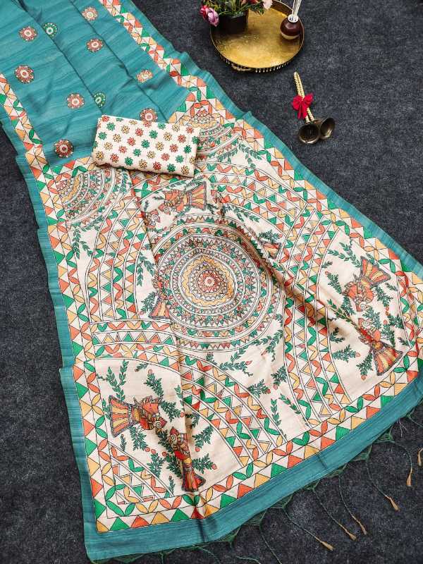 A teal and cream printed fabric set laid flat on a dark textured surface, including a large rectangular textile with intricate mandala and floral motifs, a matching small pouch, and decorative props near the top.