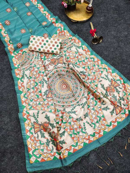 A teal and cream printed fabric set laid flat on a dark textured surface, including a large rectangular textile with intricate mandala and floral motifs, a matching small pouch, and decorative props near the top.