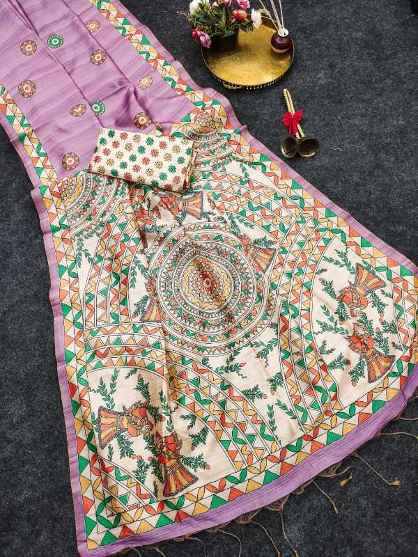A traditional Indian salwar suit set laid out on a dark gray textured surface, featuring a lavender purple kurta with colorful geometric borders, a matching printed dupatta with a central mandala design, and a small matching handkerchief.