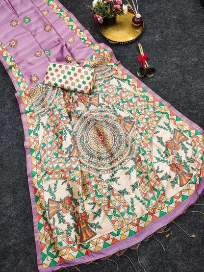 A traditional Indian salwar suit set laid out on a dark gray textured surface, featuring a lavender purple kurta with colorful geometric borders, a matching printed dupatta with a central mandala design, and a small matching handkerchief.