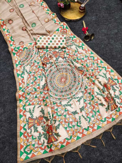 A beige cotton fabric garment laid flat on a dark gray surface, featuring intricate multicolor hand-painted motifs including a central mandala, floral patterns, and geometric borders in green, orange, red, and yellow.