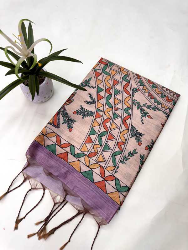 Colorful patterned scarf with purple边缘 on a white surface with a plant.