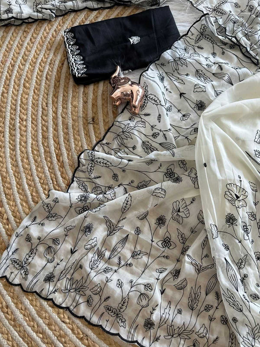 White fabric with black floral patterns on a textured surface