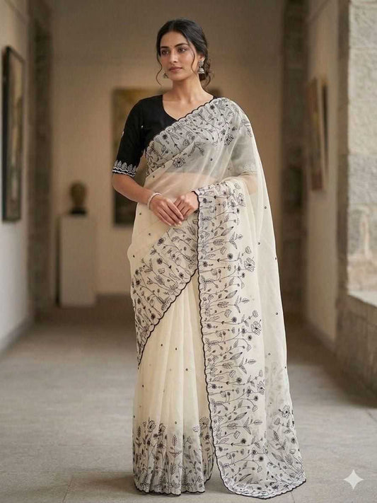 Woman wearing a traditional saree in an indoor setting