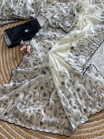 White fabric with black floral patterns on a textured surface