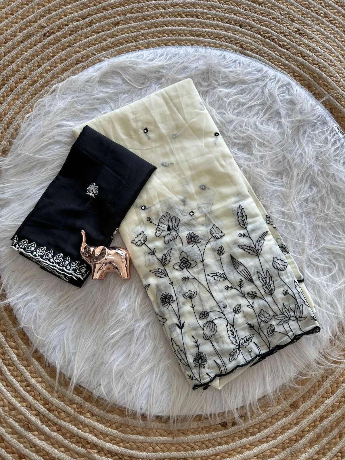 Black and white patterned fabric with floral designs on a textured surface