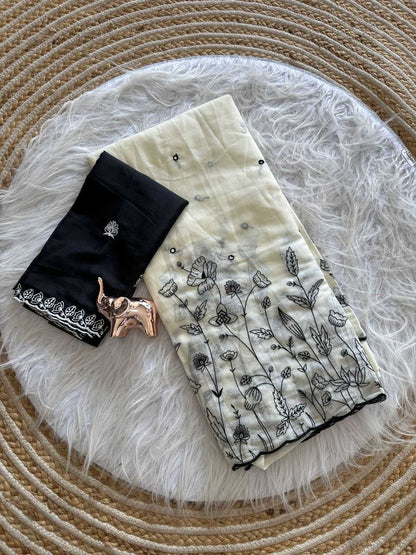 Black and white patterned fabric with floral designs on a textured surface