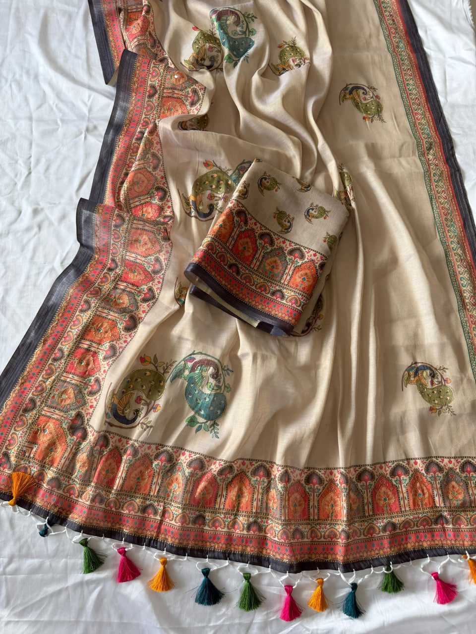 Traditional embroidered fabric with colorful patterns and tassels on a white background
