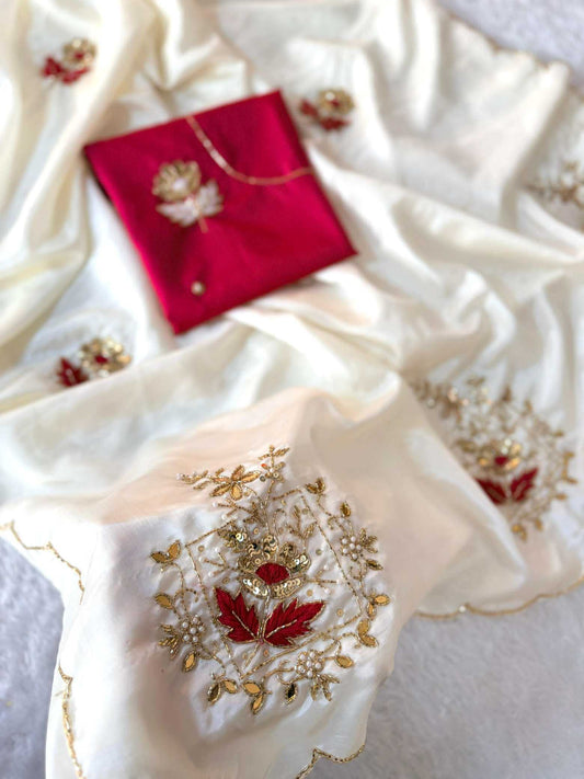 An ivory silk dupatta with intricate gold and red floral embroidery, displayed alongside a matching red embroidered pocket square on a soft white background.