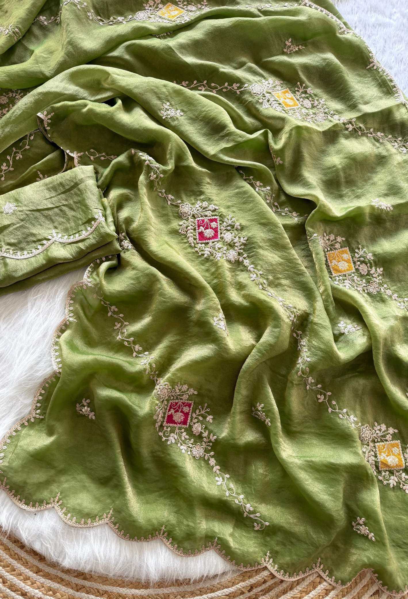 Green fabric with intricate patterns on a textured surface