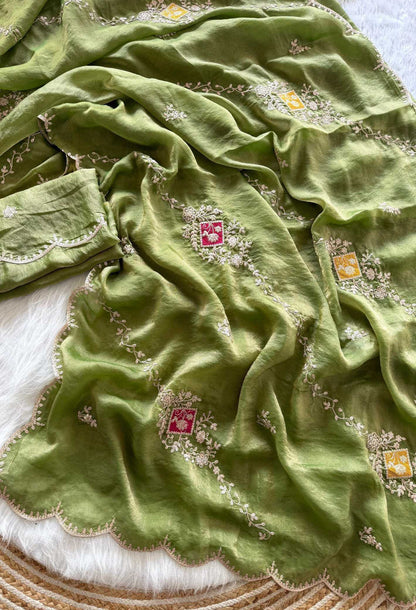 Green fabric with intricate patterns on a textured surface