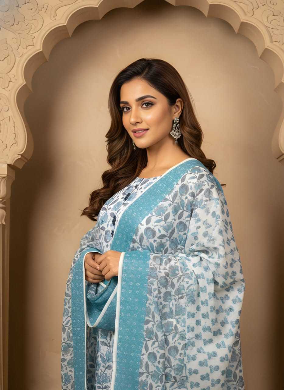 Woman in a blue and white floral traditional outfit standing in front of an ornate archway.