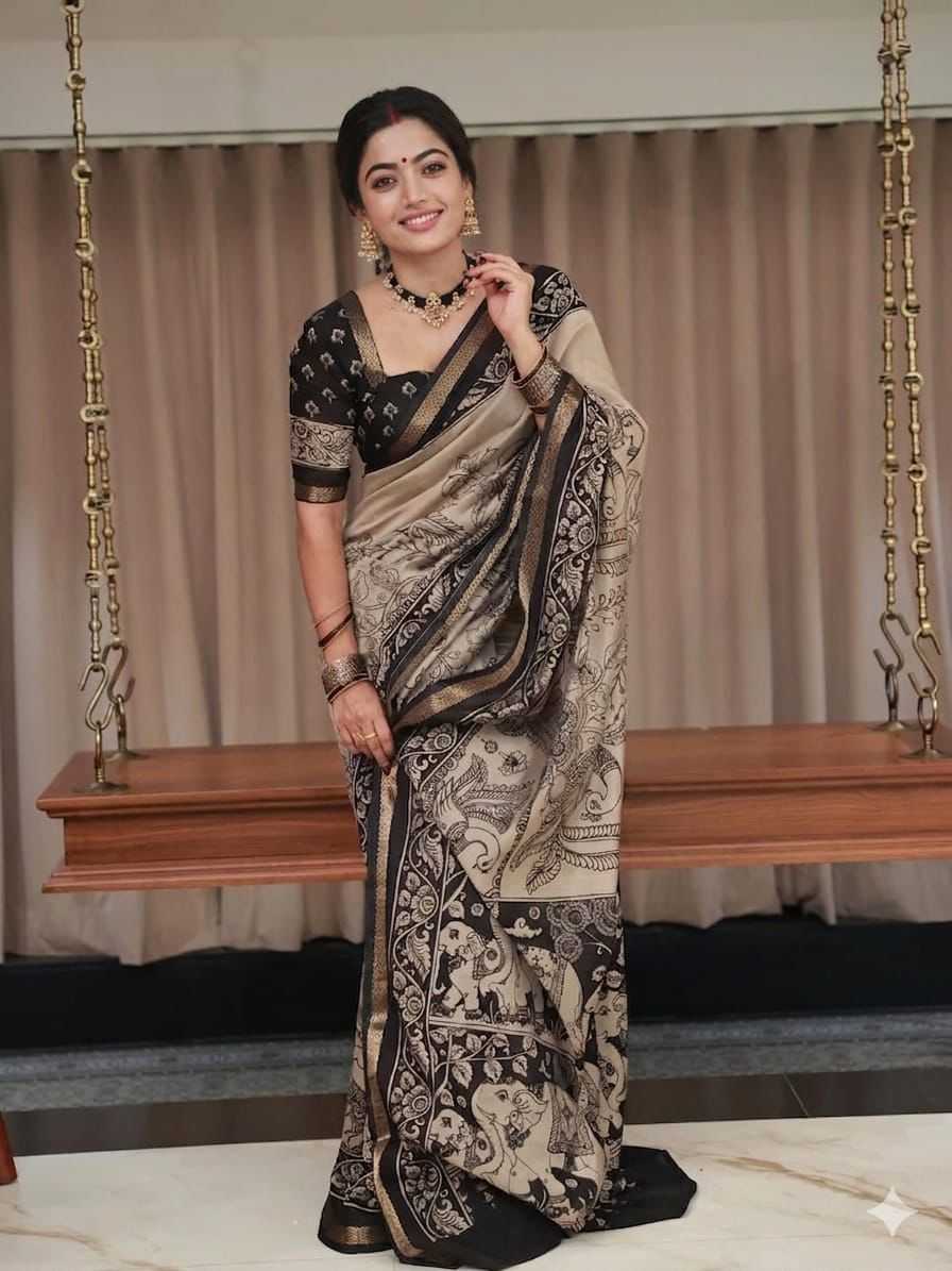 Woman in a patterned saree standing in front of a swing