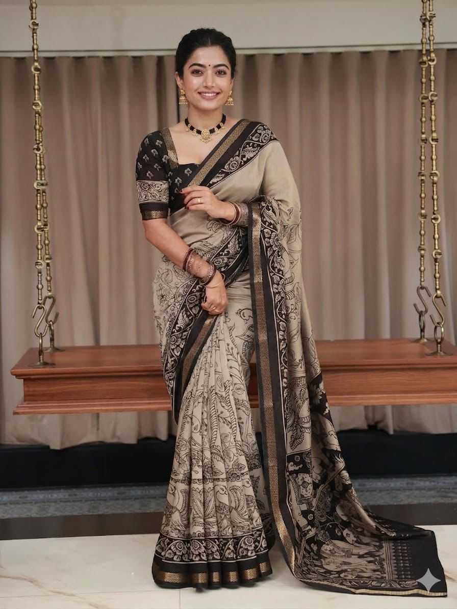 Woman in a traditional saree standing in front of a swing