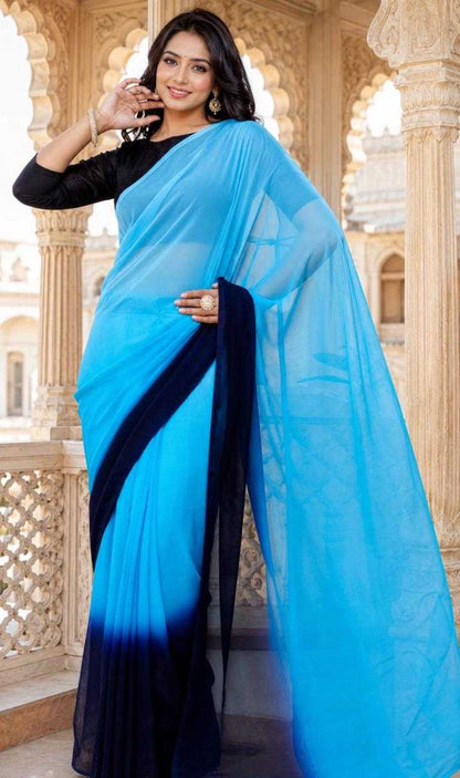 Woman wearing a blue and black saree in an architectural setting