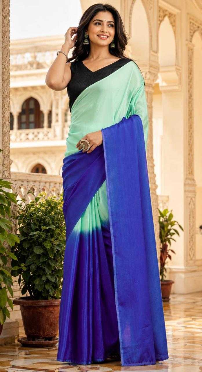 Woman wearing a multicolored saree in an indoor setting with decorative elements.