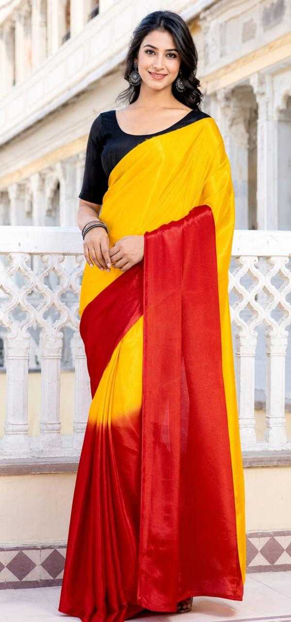 Woman wearing a yellow and red saree on a balcony