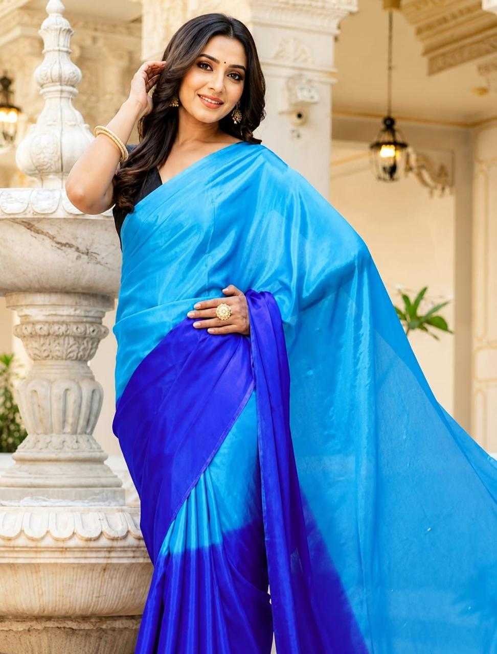 Woman wearing a blue saree with a white background