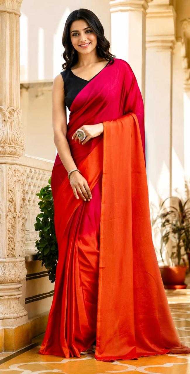 Woman wearing a red saree with a black blouse in an indoor setting