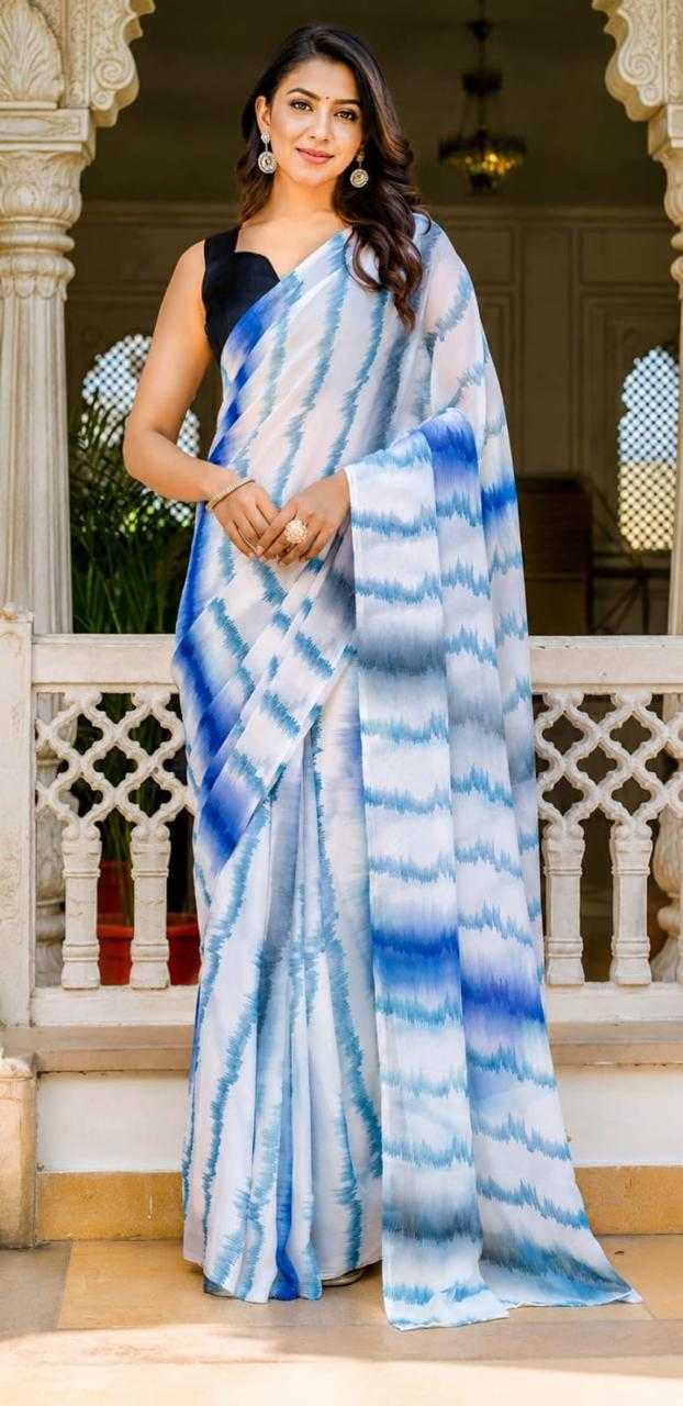 Woman wearing a blue and white saree in an outdoor setting