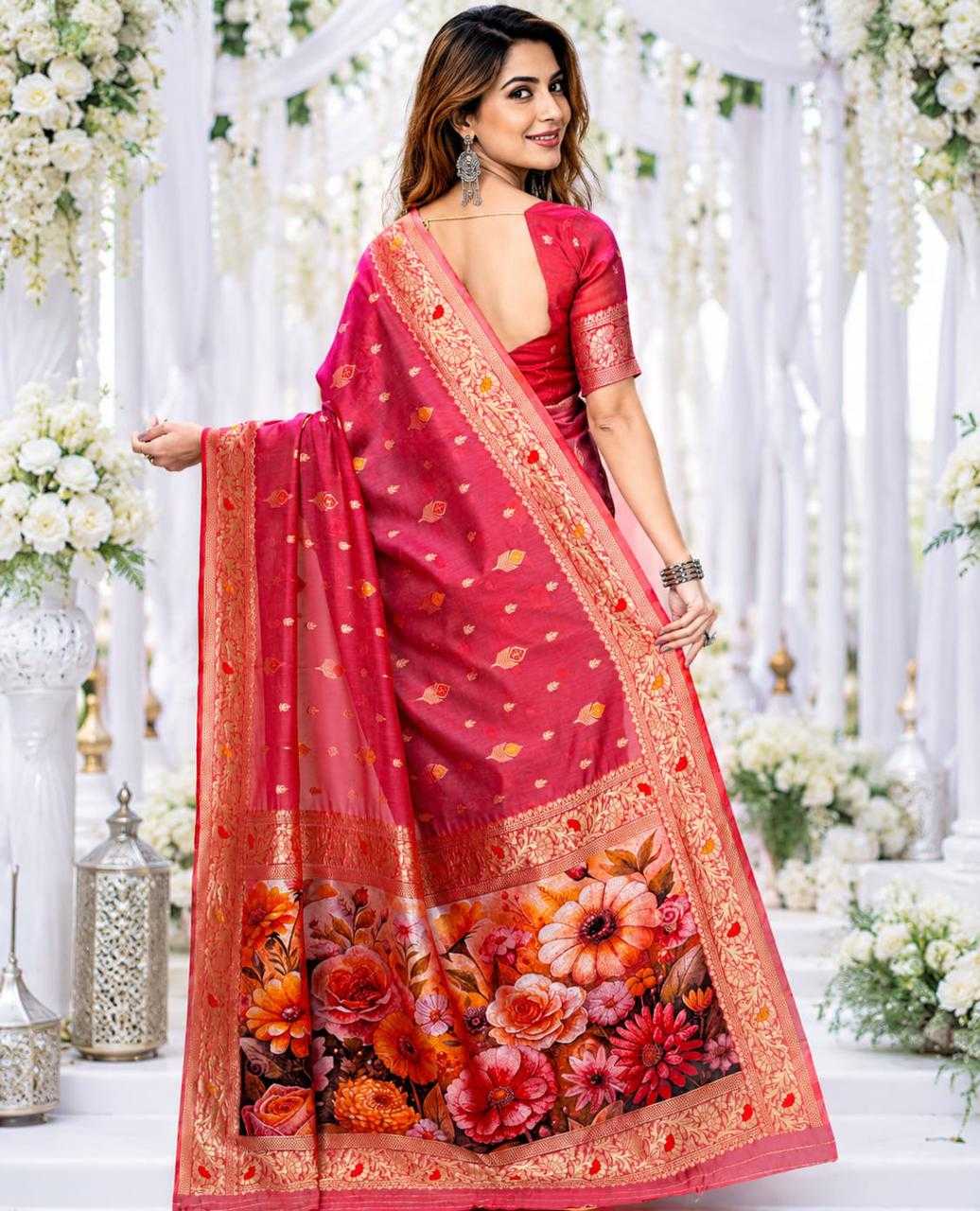 Woman wearing a red saree with floral patterns in a decorated indoor setting