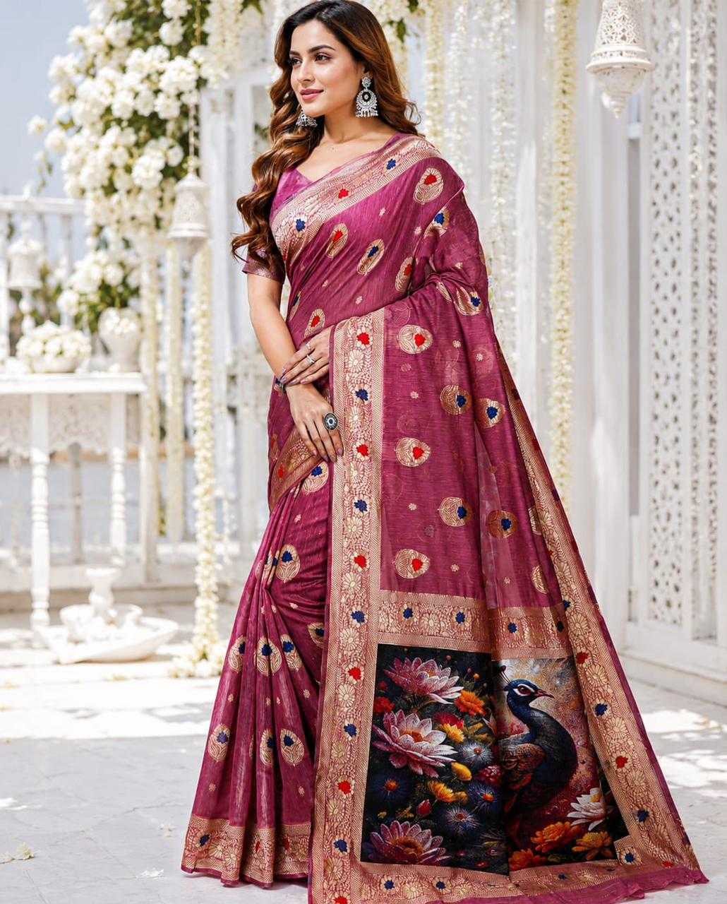 Woman wearing a maroon saree with floral and peacock design in an outdoor setting.
