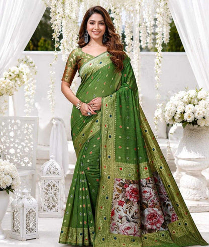 Woman wearing a green saree with floral patterns in an elegant setting.