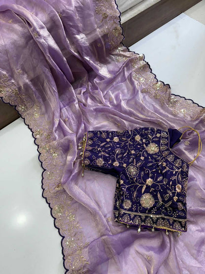 Purple saree with gold embroidery on a white surface