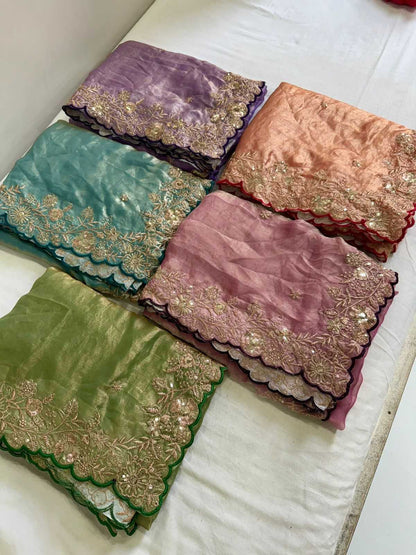 Five fabric samples with embroidered patterns in various colors on a white surface.
