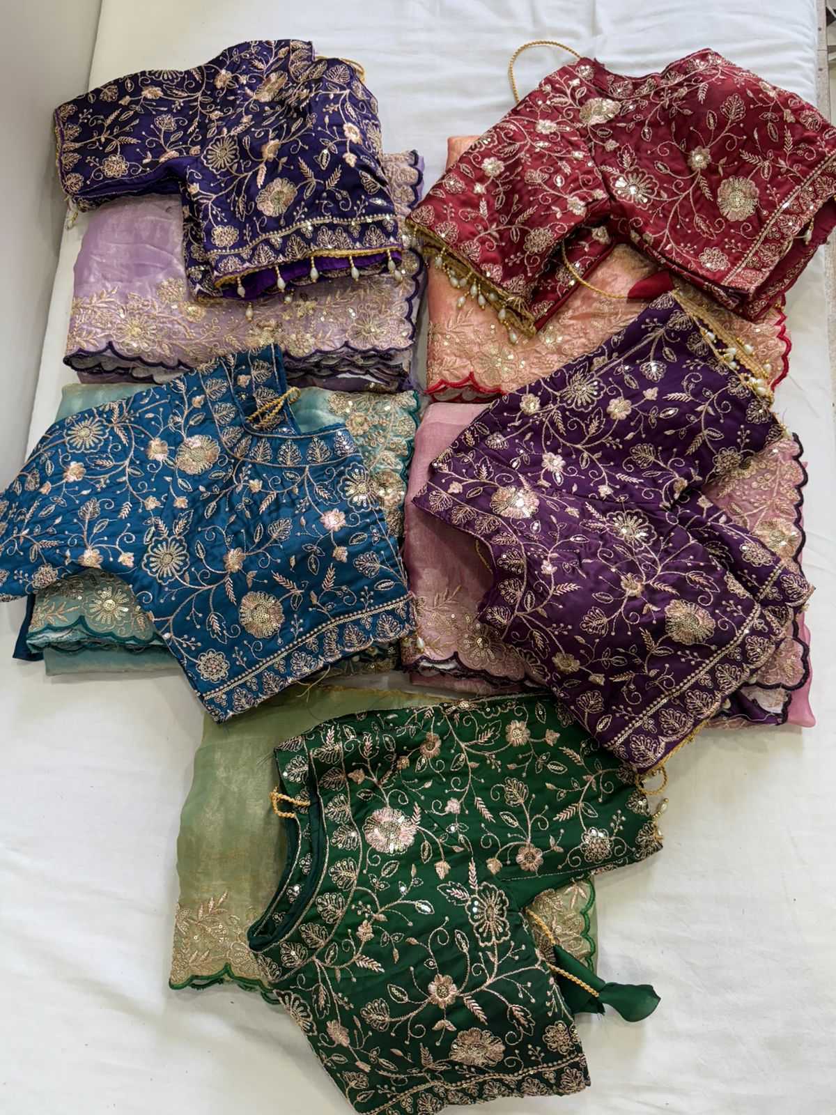 Collection of colorful embroidered fabric pieces on a white surface