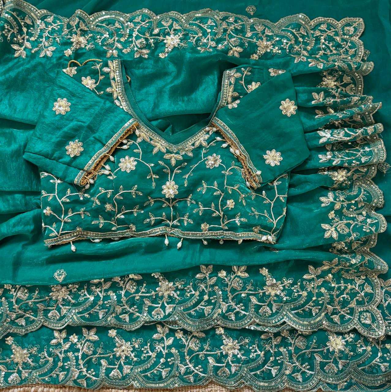 Teal fabric with intricate silver embroidery
