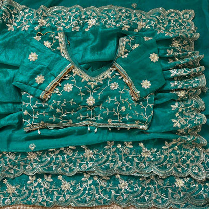 Teal fabric with intricate silver embroidery