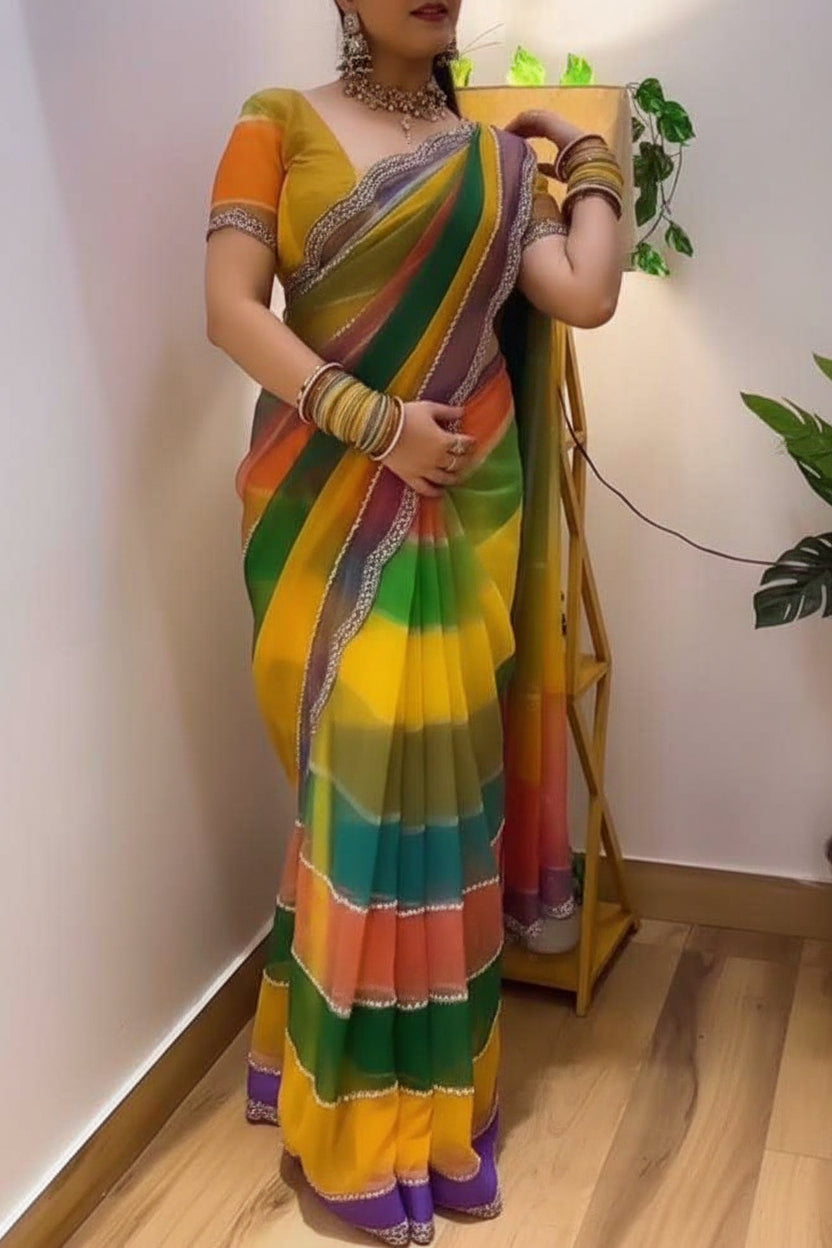 Woman wearing a colorful striped saree indoors.