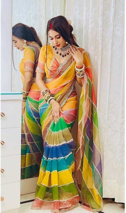 Woman wearing a colorful saree with a mirror reflection.