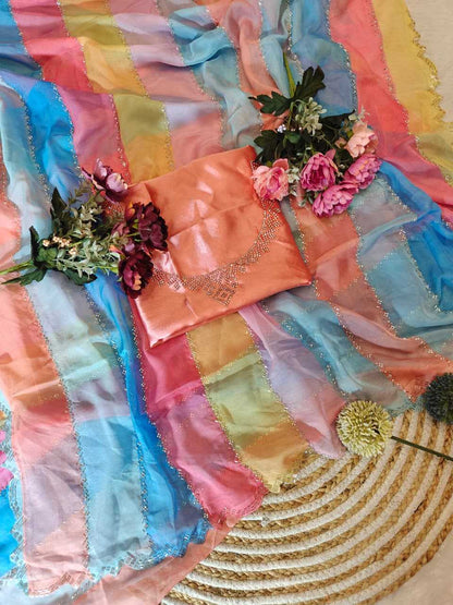 Colorful fabric with flowers and a decorative pillow on a textured surface