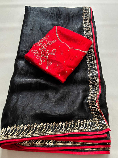 A folded black silk-like fabric with a red inner lining and ornate gold embroidered borders, with a matching red fabric piece folded on top featuring white embroidery.