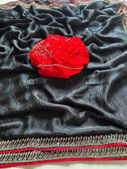 Red embroidered pouch on a black fabric with gold and red border