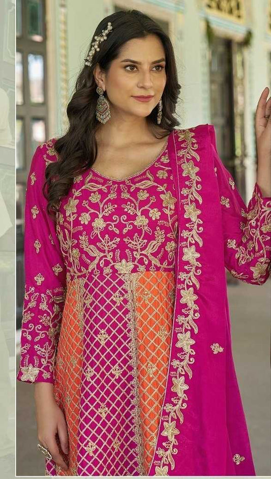 Woman wearing a pink and orange traditional outfit with gold embroidery.