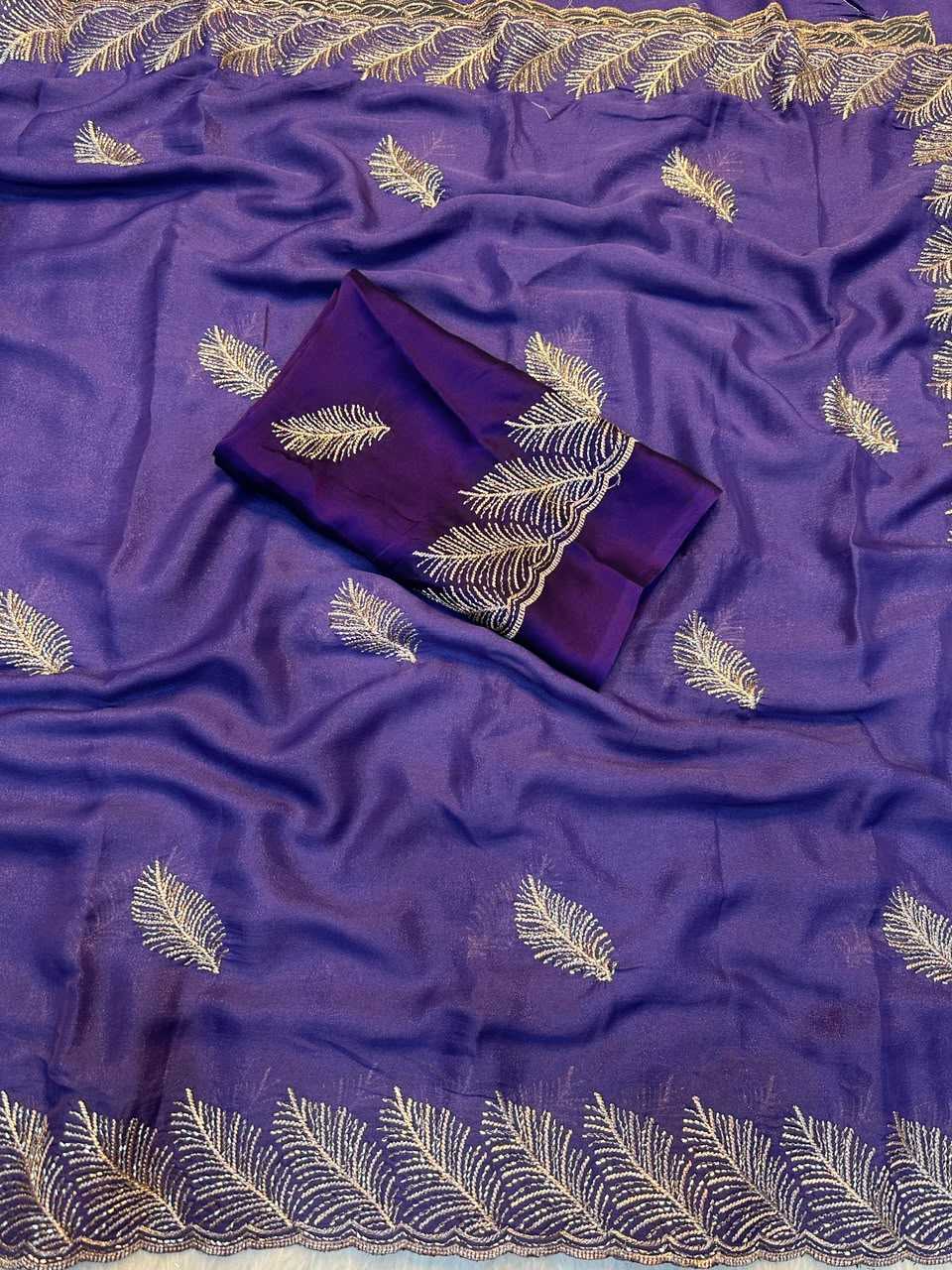 Purple silk-like fabric with gold embroidered leaf motifs and a matching folded fabric piece, laid out on a white background.