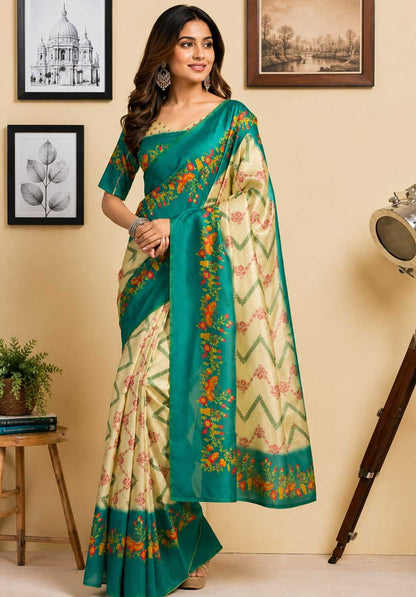 Woman wearing a green and beige saree with floral patterns in a room setting.