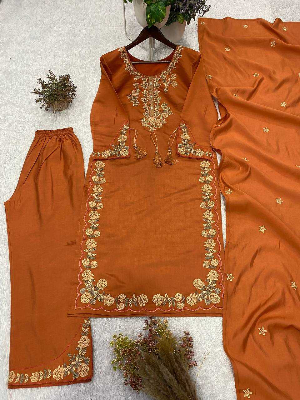 Orange embroidered traditional outfit with matching pants on a white background