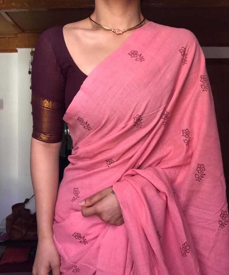Person wearing a pink saree with a blurred background