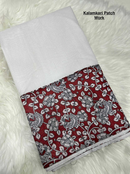 White fabric with red and black floral patterned border on a white background