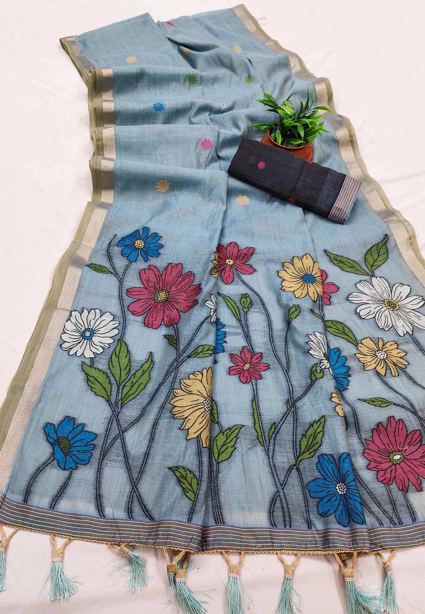 Light blue saree with floral embroidery on a white background