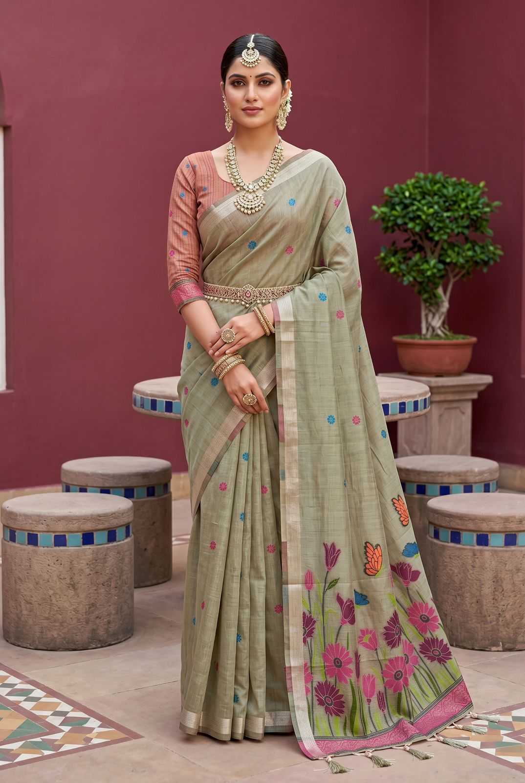 Woman in a traditional saree with floral patterns in a decorative setting