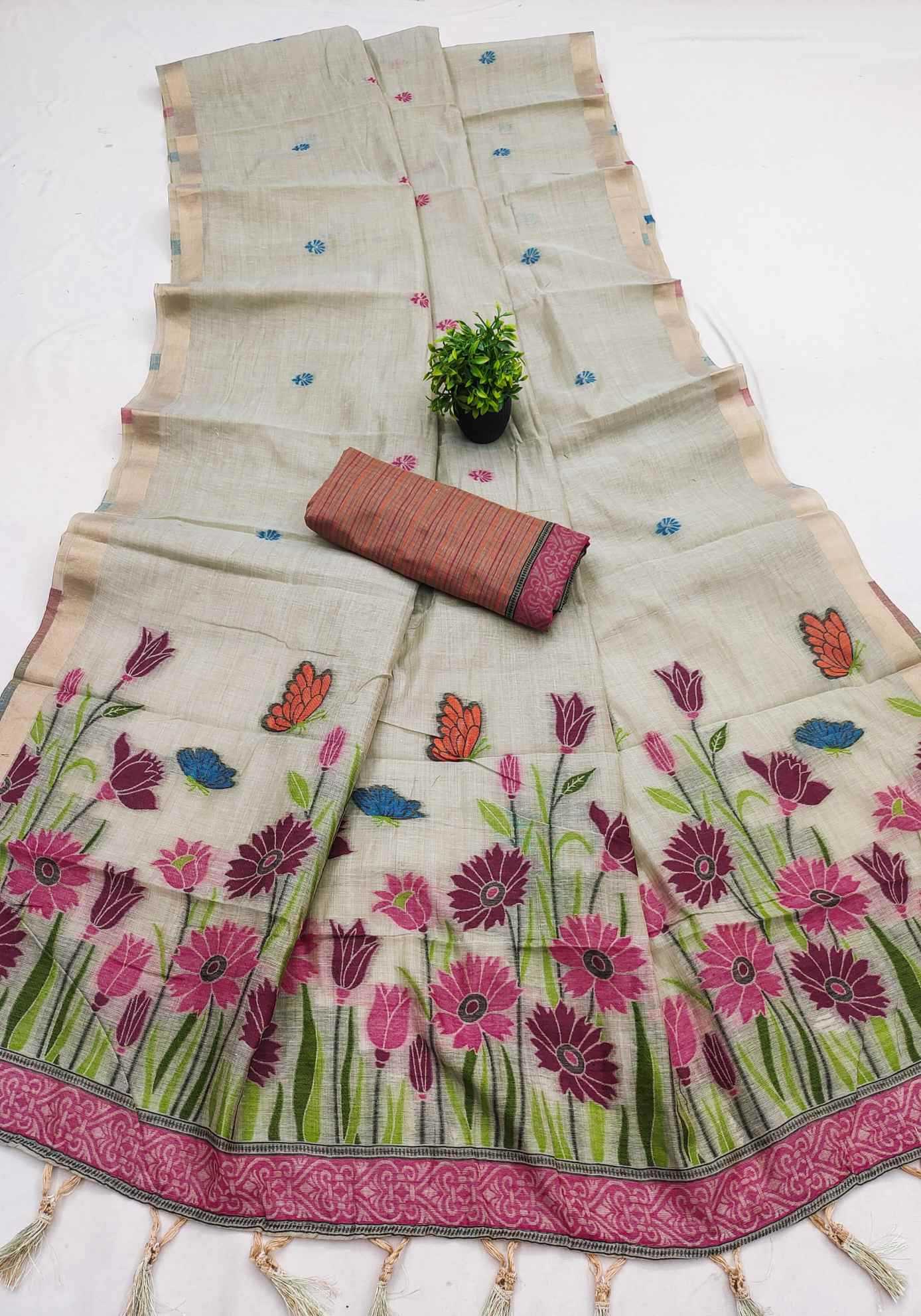Floral embroidered saree with a small plant and pouch on a white background