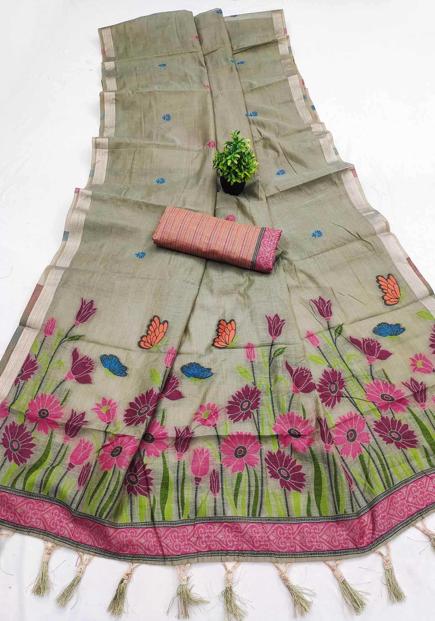 Floral embroidered saree with a pink border on a white background