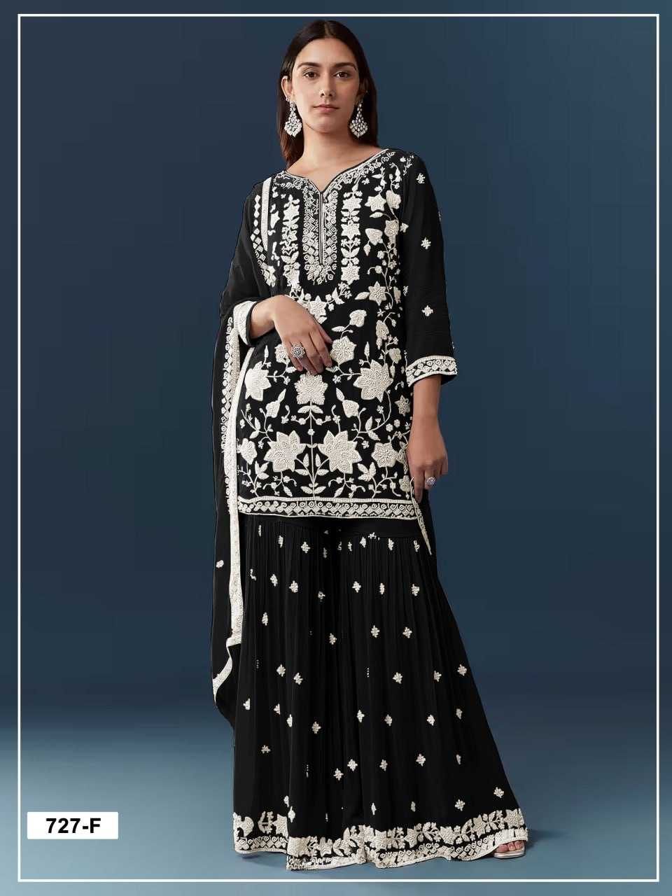 Woman wearing a black and white embroidered traditional outfit on a blue background