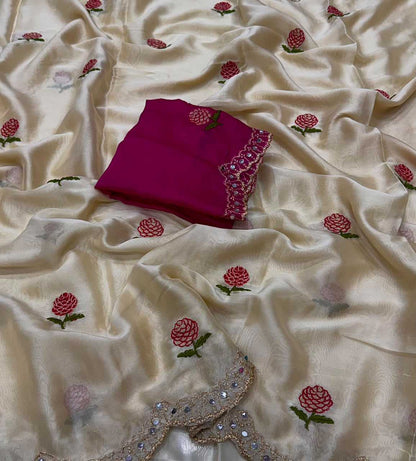 A cream-colored silk dupatta with embroidered red and pink floral motifs and a matching folded magenta fabric piece with embellished border, displayed on a white background.