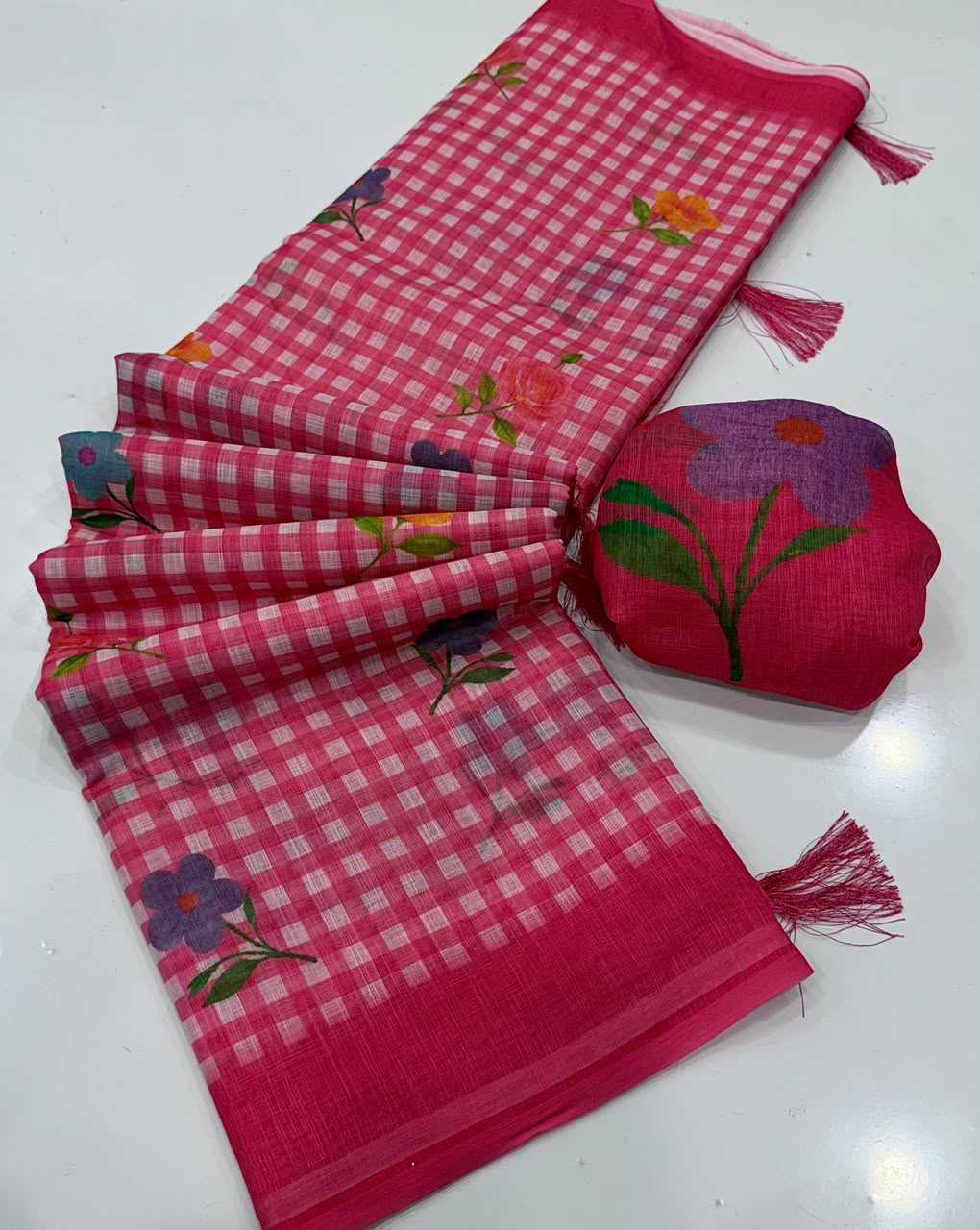 Pink checkered fabric with floral embroidery and a matching pouch on a white background